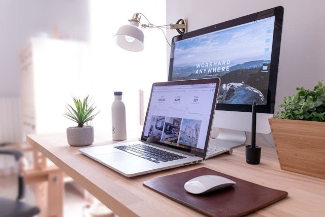 A desk with a laptop and monitor set up for local development and testing.